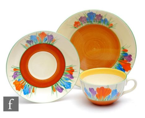 A Clarice Cliff composed Globe shape cup, saucer and side plate hand painted in the Crocus pattern, with Crocus sprays with g