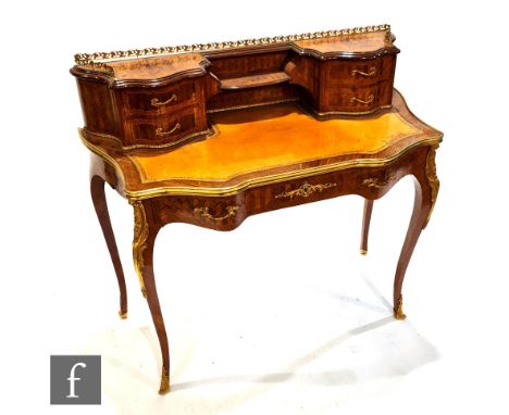 A late 19th to early 20th century Bon-heur-de-jour, the superstructure fitted with four serpentine short drawers centred by a