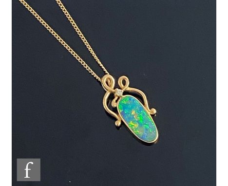 A 14ct oval opal doublet and diamond set pendant, collar set opal below a single diamond, suspended from a 9ct fine trace cha