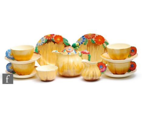 A Clarice Cliff tea service circa 1934, comprising teapot, milk, sugar, four cups and saucers and two side plates, in the Mar