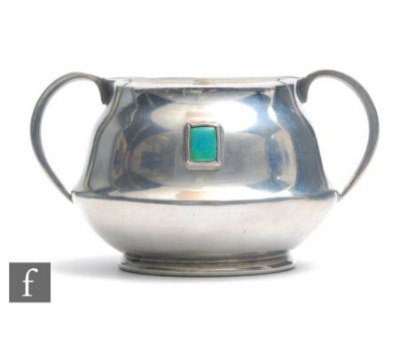 A William Hutton &amp; Sons Arts &amp; Crafts twin handled pewter sugar bowl, inset with Ruskin cabochon, stamped Hutton. She