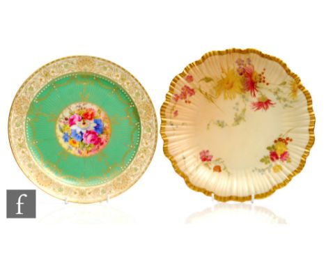 A small Royal Worcester cabinet plate decorated by Phillips with a hand painted spray of flowers to the central roundel withi