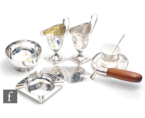 A small parcel lot of assorted hallmarked silver items, a wooden handle trowel, two Georgian helmet cream jugs, a lined cup a