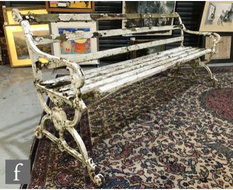 A 19th Century white painted cast iron and wooden slatted garden bench, pierced open scroll ends, length 184cm,&nbsp;A/F. 