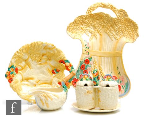 A large Clarice Cliff dish relief moulded as a&nbsp;wheat sheaf with scythe and poppies picked out in enamel colours, printed