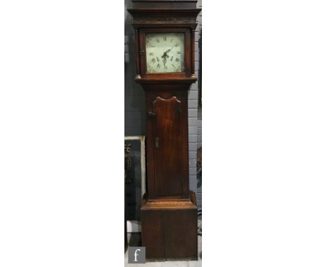 An early 19th Century 30 hour oak longcase clock, the pillared hood enclosing an 11 inch square painted dial with date apertu