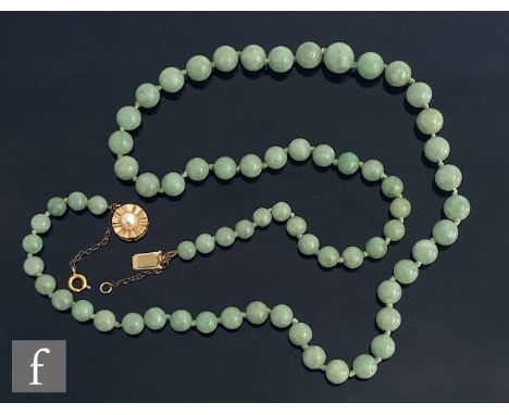 A single row of graduated jade beads terminating in a pearl set 14ct circular clap, total weight 50g, length 60cm. 