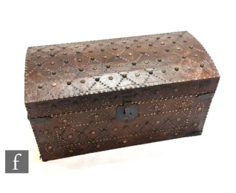 An early to mid 20th Century domed Moorish leather covered iron studded trunk, the front decorated with castellated, oval and