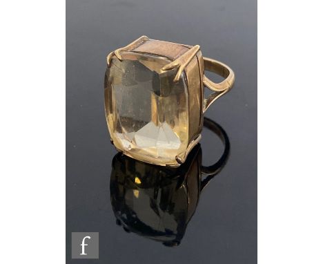 A 9ct single stone citrine ring, cushioned emerald cut stone, length 22mm, to a basket setting and split shoulders, weight 14