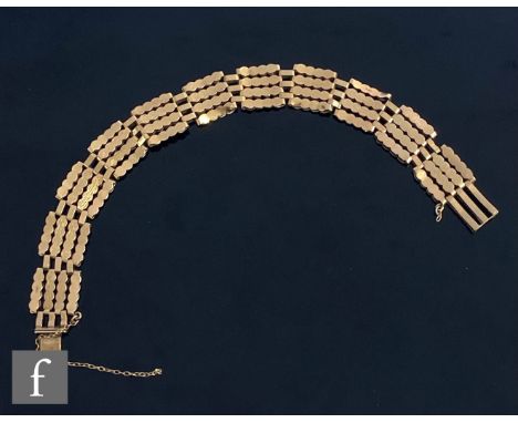 A 9ct four bar gate bracelet decorated with plain and bark effect links, weight 13.5g, length 21cm, terminating in tongue and