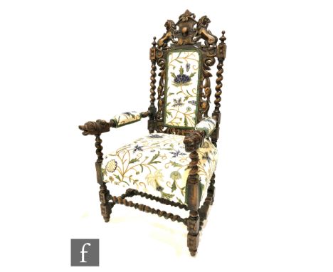 A Victorian carved oak elbow chair, the armorial lion back above twist supports over lion arms on conforming legs and stretch
