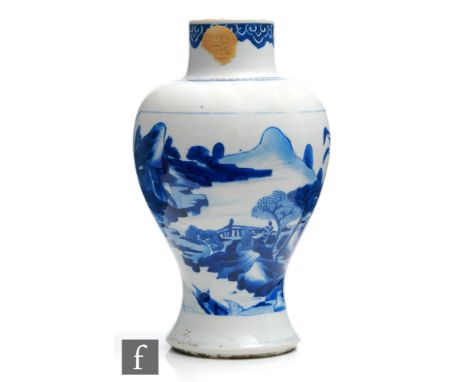 A Chinese Kangxi period (1662-1722) blue and white baluster vase, the splayed foot extending to a rounded body with opposing 