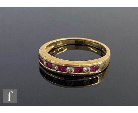 An 18ct hallmarked ruby and diamond half eternity ring comprising nine alternating channel set stones to a plain shank, weigh