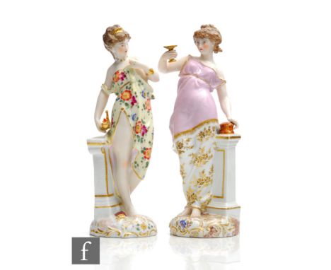 Two 19th Century Dresden type figurines, the first a lady stood draped in robes holding aloft a gilt goblet stood beside a pe