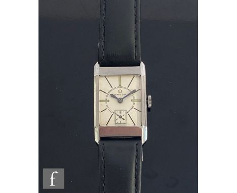 A mid 20th Century stainless steel Omega manual wrist watch, batons to a rectangular cream dial, case width 22mm, to a black 