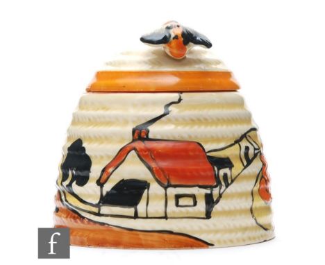 A large Clarice Cliff Beehive honey pot circa 1932, hand painted in the House &amp; Bridge pattern with a stylised tree and c