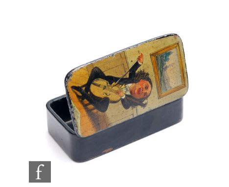 A 19th Century rectangular papier mache snuff box printed with a seated humorous character playing the cello, width 8.5cm. 