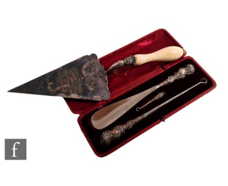 A case hallmarked silver handled shoe horn, glove and button hook set, with a silver plated presentation trowel, Birmingham 1