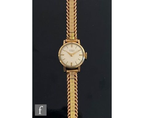 A mid 20th Century Strad manual wrist watch, batons to a silvered dial, case diameter 20mm, all to a 9ct bracelet with curb l