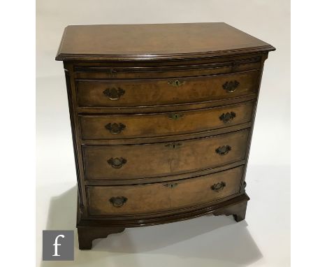 A George I style bow front walnut bachelors chest of four long drawers, brass fret drop handles, canted sides, on bracket fee