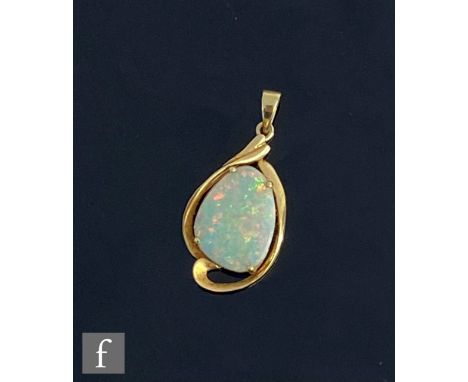 A 14ct single stone opal pendant, claw set shaped oval stone within a plain scroll border, weight 2.5g, length 3cm. 