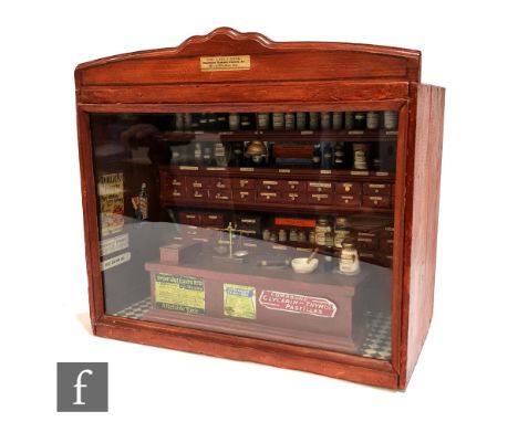 A 20th Century replica wooden miniature chemist's shop named 'Cary Cocks &amp; Roper Dispensing Chemists, Dentist etc, Man of