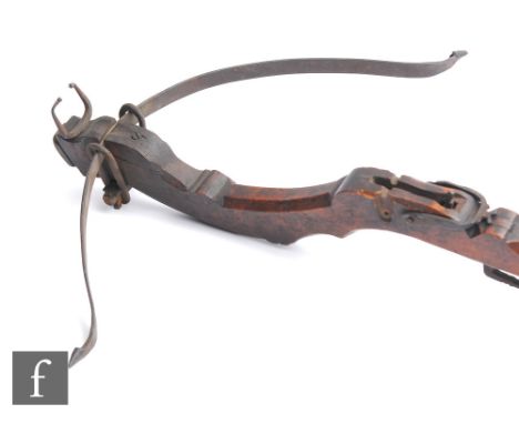 A 19th Century Medieval style carved mahogany crossbow with iron fittings and trigger, pommel end, length 98cm. 