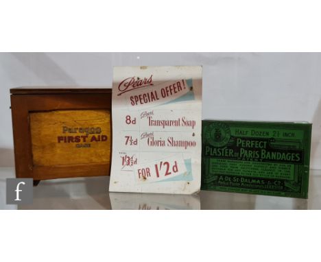 A Paragon wooden first aid case and contents, width 25cm, a green tin for half dozen ?Perfect Plaster of Paris Bandages? by A