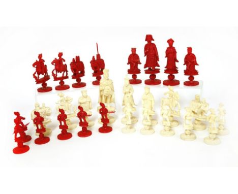 A Chinese ivory part chess set, late 19th century, the unstained pieces carved as Western figures, the stained pieces as Orie