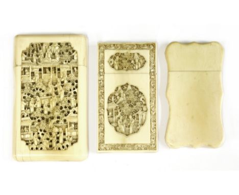 Three Chinese Canton ivory card cases, 19th century, one carved with figures, trees and pavilions in a garden in shaped panel