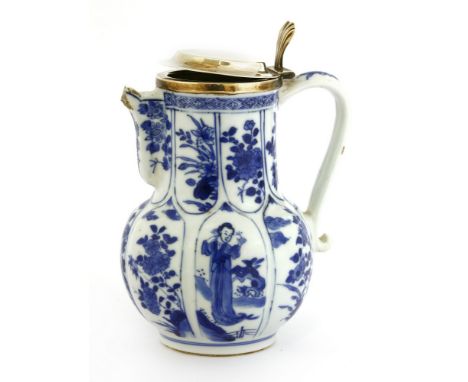A Chinese blue and white jug, Kangxi (1662-1722), of lobed form, painted with figures and flowers in shaped panels, with a si