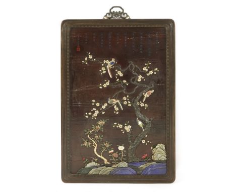 A Chinese wood hanging panel, inlaid with birds standing on a blossoming gnarled tree, surrounded by flowers and rocks, in ja