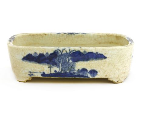 A Chinese blue and white planter, c.1900, of shaped rectangular form on four bracket feet, painted with landscapes, the rim w