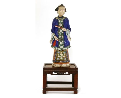 A Chinese painted clay nodding-head figure, late 18th/early 19th century, of a lady standing in a long blue robe with foliage