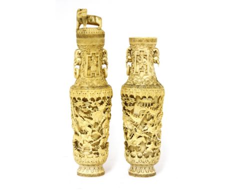 A pair of Chinese ivory vases, late Qing dynasty, of tapering baluster form, deeply carved with warriors on horseback at batt