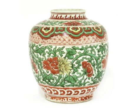 A Chinese famille verte jar, 17th century, of ovoid form, painted with peony in red and yellow amongst tendrils below a ruyi 
