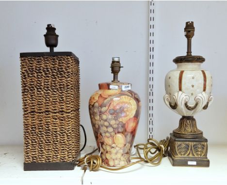 Two contemporary ceramic table lamps, the first oviform, printed with fruit, the second vase-shaped and scroll-moulded, on 'b