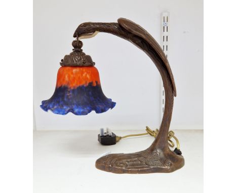 Contemporary bronzed cast metal Art Nouveau style table lamp and opaque glass shade, cast as a stylised bird of prey suspendi