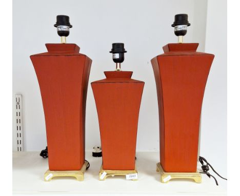 Three contemporary Aimbry Lighting ceramic table lamps in two sizes, each of waisted shouldered square section form, on gilt 