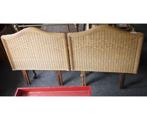 A pair of single wicker headboards and a wooden standard lamp with carved pedestal on circular base