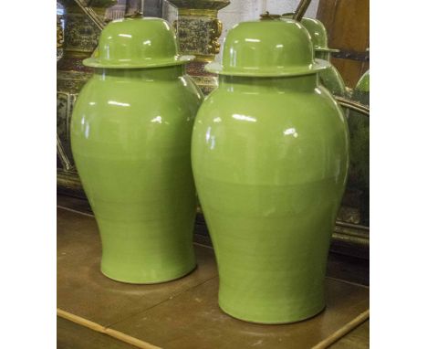 TEMPLE JARS, a pair, Chinese green leaf ceramic vase form with lids, 67cm H. (2)