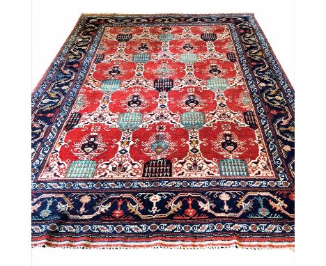 FINE KAZAK DESIGN CARPET, 220cm x 298cm. of scrolling vines on ruby field within sapphire borders