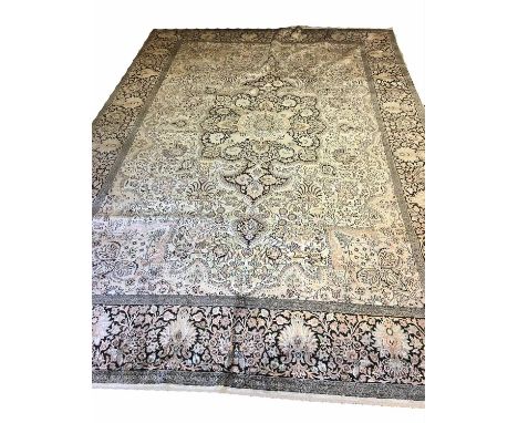 FINE PURE SILK TERHAN DESIGN CARPET, 380cm x 255cm, noir medallion on ivory field within corresponding border.