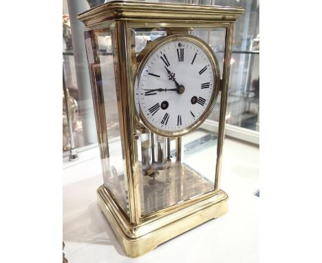 Late 19thC brass framed mantel clock with bevelled glass side panels and mercury weighted pendulum chimes on a bell movement 