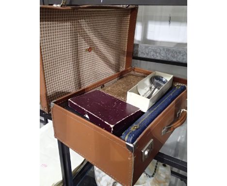 Mixed boxed cutlery in a vintage suitcase 