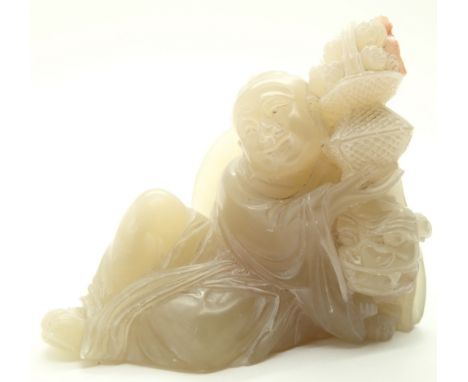 Carved jade Buddha holding a lamp H: 6 cm