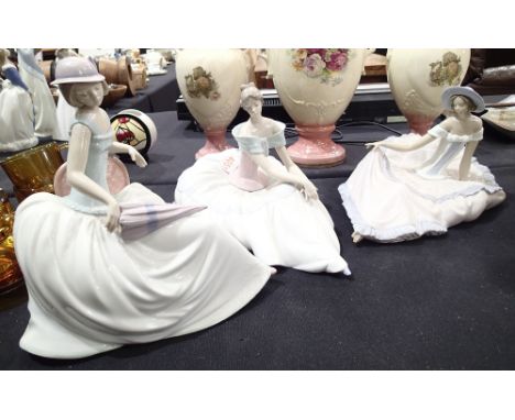 Three large Nao female figurines all with flowing dresses 