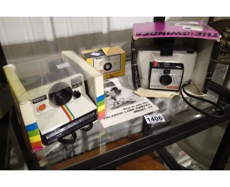 Two Polaroid cameras and a boxed Instamatic 
