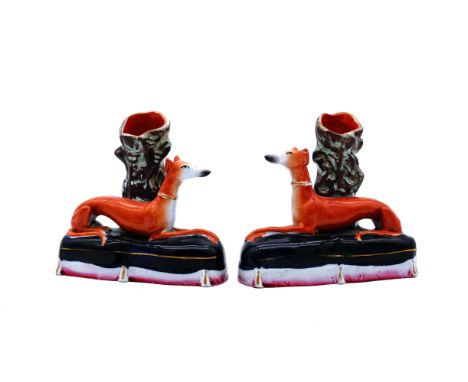GREYHOUNDS: A nicely modelled pair of Staffordshire Pottery Spill Vases, modelled as Greyhounds, mid 19th century,  each recu
