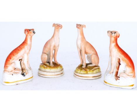 GREYHOUNDS: Two pairs of Staffordshire Pottery Dogs, modelled as seated Greyhounds, mid 19th century,  a slender well modelle
